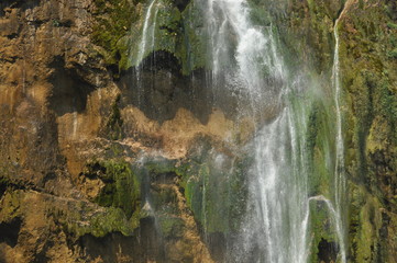 High waterfall, the water flowing from the rocks into the lake. National Park Plitvice Lakes. Tourism in Croatia.