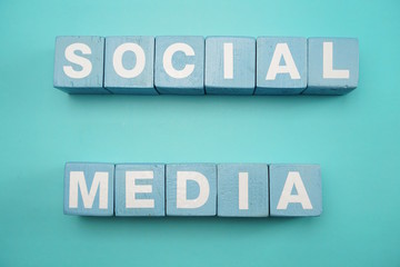 Social Media created with cubes alphabet letters on blue background