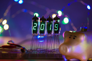 Happy new year is written with a lamp light. Radio electronic lamps. 2019. Symbol of the year pig....