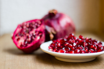 Pomegranate fruit (Latin: Punica granatum) is an exotic fruit with many vitamins and antioxidants. It is used within fruit juices and medicine. Selective focus.