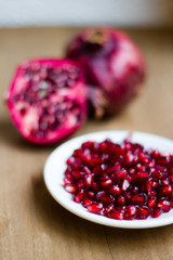 Pomegranate fruit (Latin: Punica granatum) is an exotic fruit with many vitamins and antioxidants. It is used within fruit juices and medicine. Selective focus.