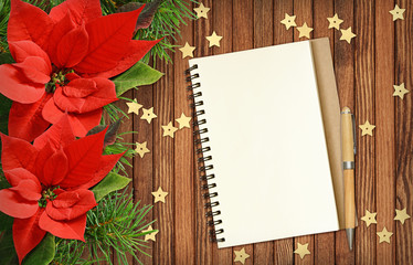 Christmas poinsettia flowers and notepad
