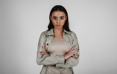 Portrait of a girl of Asian appearance on a white background in a raincoat, body