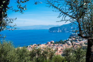 Naklejka premium Above view of Sorrento Naples Campania Italy holiday beautiful city place. Mediterranean scenic place with blue sea and high cliffs mountains. Naples and Vesuvio in background
