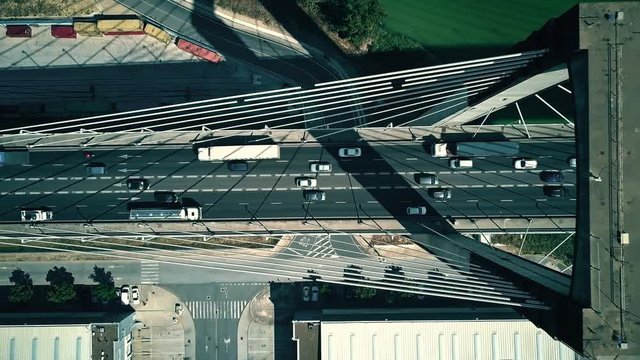 Aerial top-down view of modern cable-stayed bridge traffic