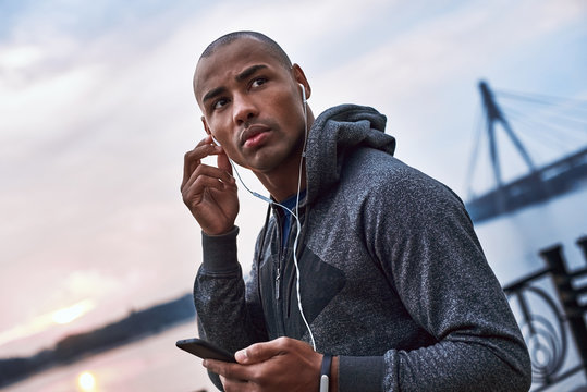 The Young Black Athlete Is Listening To Music After Training In The City