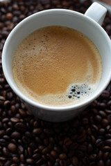 cup of americano coffee on coffee beans.