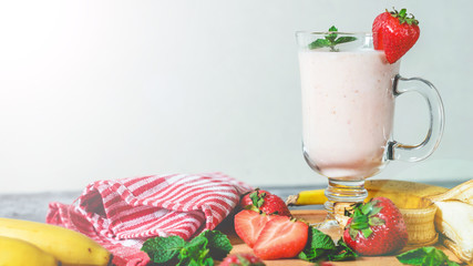 banana and strawberry smoothies with mint on the table, front view