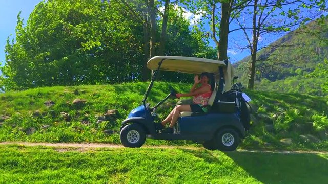 Woman Driving a Golf Cart and Greeting with Sunbeam.