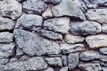 Unusual background with raw natural porous stone.