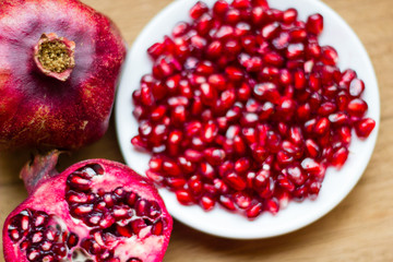 Pomegranate fruit (Latin: Punica granatum) is an exotic fruit with many vitamins and antioxidants. It is used within fruit juices and medicine. Selective focus.
