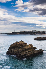 Rock covered in crosses in the sea off the coast of Biarritz, France