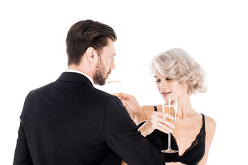Attractive couple clinking glasses of champagne isolated on white