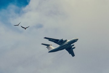 Transport airpcraft flying in the sky. View from the ground