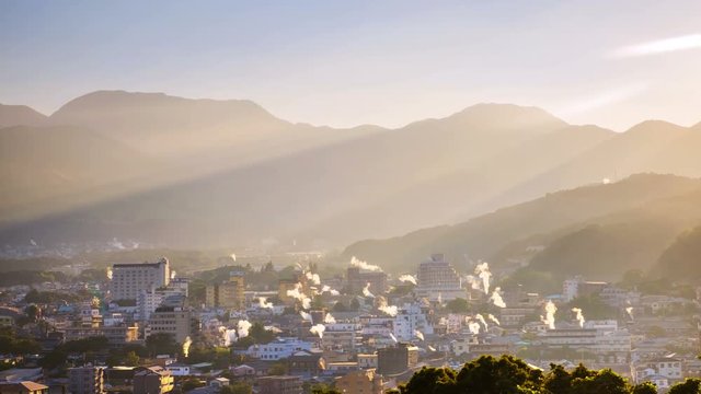 Beppu, Japan. A sunset time-lapse in a resort town of Beppu, Japan, with a view of mountains embracing the city and layers of sun