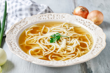 Broth soup in ceramic plate.