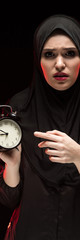 Naklejka premium Portrait of woman with alarm clock