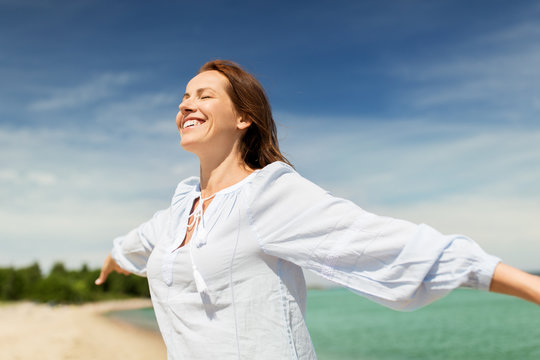 people and leisure concept - happy smiling woman on summer beach