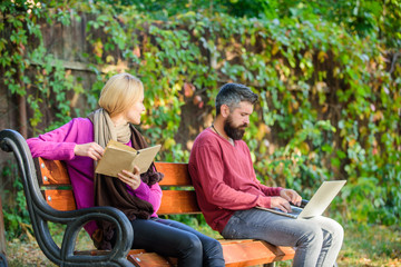 Couple spend leisure reading. Couple with book and laptop search information. Use digital approach...