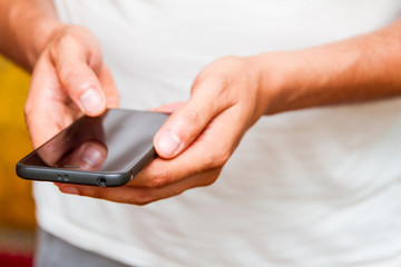 Male hands using smartphone. person holding a tactile mobile smartphone