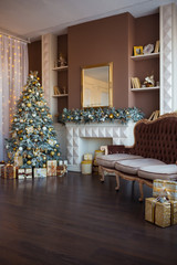 Christmas background. Luxury interior room with fireplace decorated in xmas style. No people. New year tree and gifts