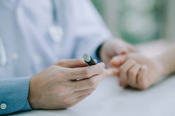 Fototapeta premium Doctor or technicain checking the blood-sugar level in the hospital room.