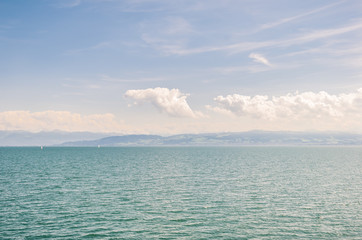 Obraz premium View of the Bodensee Lake (Lake Constance) from the side of the city of Friedrichshafen, Germany. Switzerland is on the opposite side of the lake