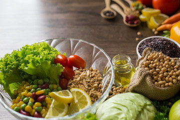 Healthy food background ,fruits and vegetables with salad bowl on wooden table.