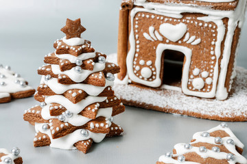 Gingerbread Christmas tree and house on silver background