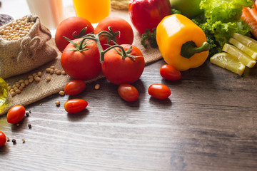 A Low key picture of Healthy food background ,fruits and vegetables on old wooden table.