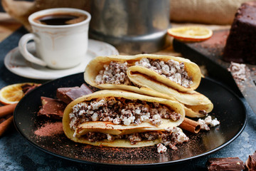 Crepes filled with chocolate and cottage cheese.