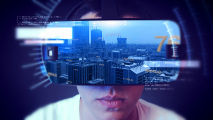 Fototapeta premium Young man wearing VR headset and watching business and economy related graphics.