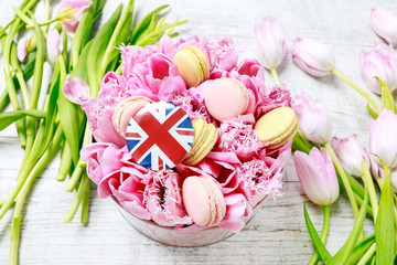 British flag on dotted pink box with tulips and parisian macaroons.