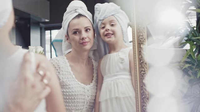 Woman and daughter making a skin care and hair care routines