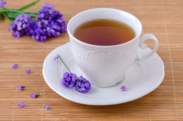 cup of healing tea with fresh lavender flowers, selective focus