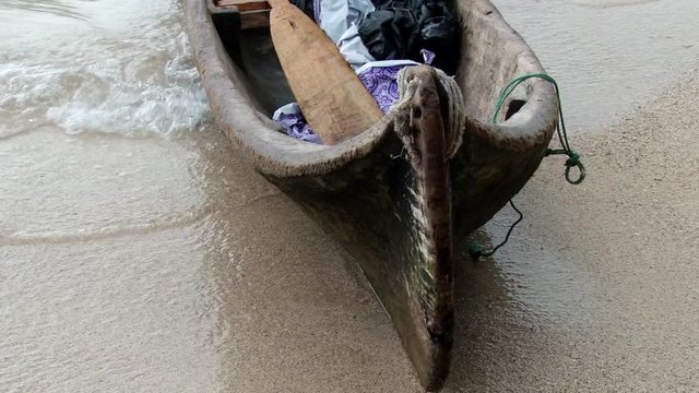 Traditional Indigenous Guna canoe on beach  in the San Blas Islands during stormy day.