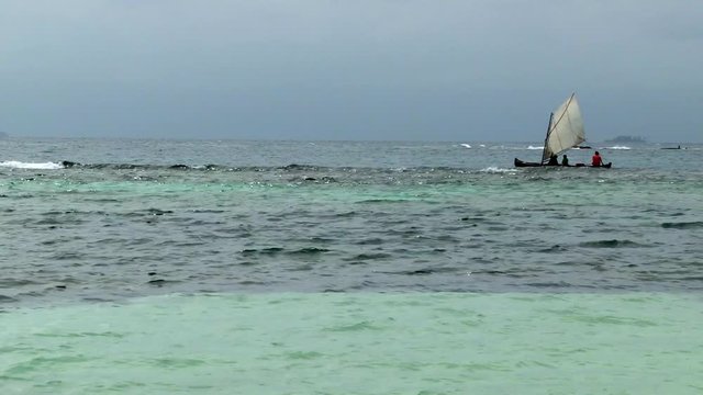 Indigenous Guna sailing canoe in the San Blas Islands on a stormy day