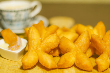 Asian traditional food Close up of deep fried dough stick and Soybean milk ,Snack or breakfast concept.on wooden background.