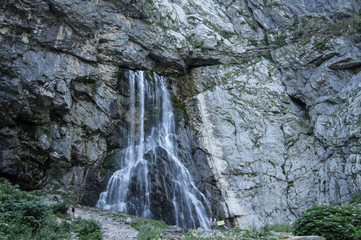 Naklejka premium Vertical picturesque natural landscape mountain waterfall