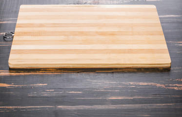 striped cutting board lying on a wooden tabletop