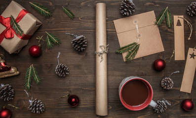New Year or Christmas concept, wrapping paper, cup of coffee, fir branches, cones, gift, on wooden...