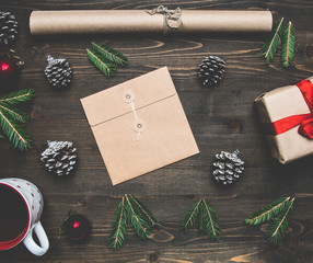 New Year or Christmas concept, wrapping paper, cup of coffee, fir branches, cones, gift, on wooden background flat lay