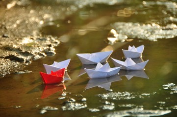 Leadership concept of team leader with paper boats