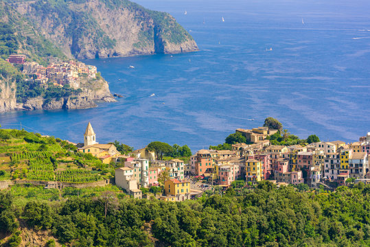 Corniglia - Village of Cinque Terre National Park at Coast of Italy. In the background you can see Manarola. Province of La Spezia, Liguria, in the north of Italy - Travel destination in Europe.