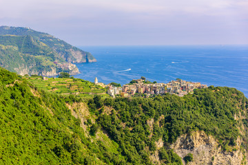 Corniglia - Village of Cinque Terre National Park at Coast of Italy. In the background you can see Manarola. Province of La Spezia, Liguria, in the north of Italy - Travel destination in Europe.