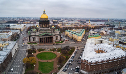 Fototapeta na wymiar Aerial; autumn cloudscape over the famous Isaak Cathedral in the cultural capital of Russia; bright golden dome in the fog; royal time historical part of Sain Petersburg background; a lot of tourists