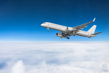 Fototapeta na wymiar Passenger plane fly on a train above clouds and blue sky.