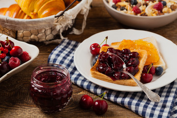 Breakfast. Toasts with cherry or peach jam and fresh fruit.
