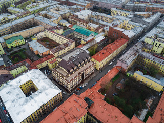 Autumn cloudy day with view of city rooftops; different architecture style houses, mansions with cultural history; popular touristic rout in Saint Petersburg with usual foggy cityscape;