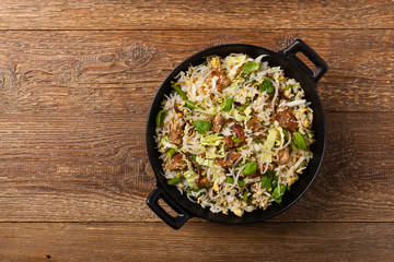 Fried veal, with rice, Chinese cabbage and mushrooms. Sprinkled with sesame and soy sauce.